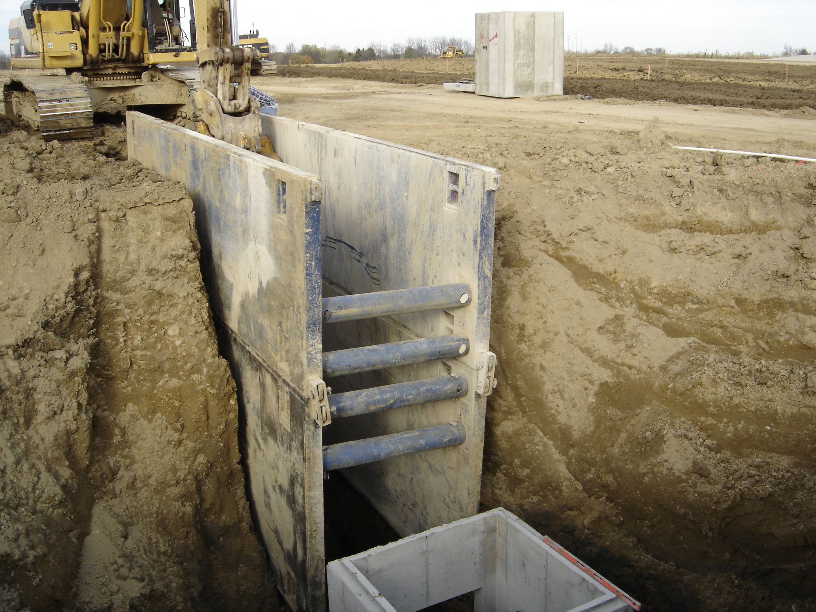 steel wall shield in use at trench shoring job site