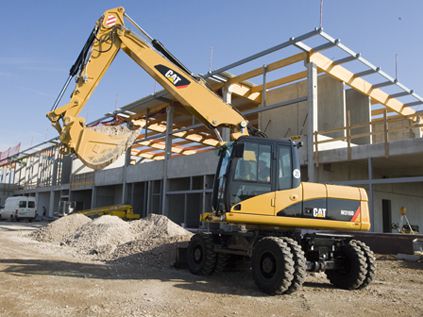 CAT wheel excavator transporting gravel at construction site