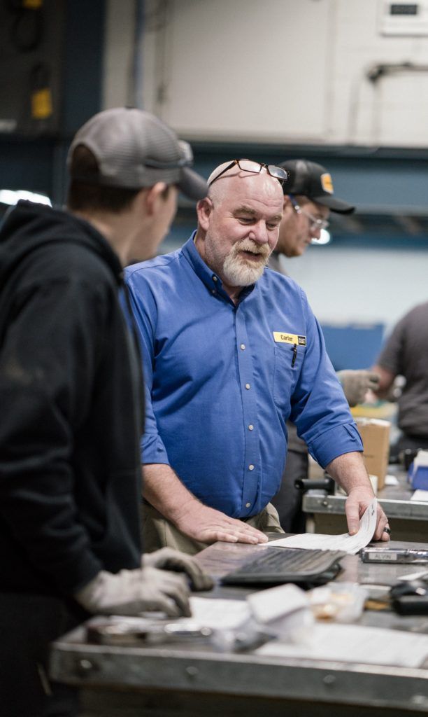 Man teaching carter machinery career student