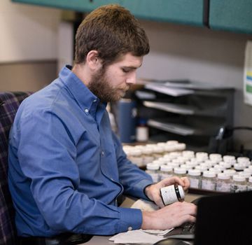 A Carter Cat employee conducting an analysis