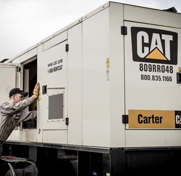 A Carter Cat employee working on a Carter Cat power system