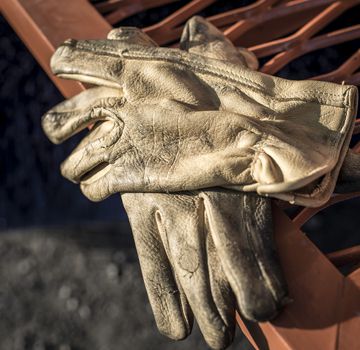 A pair of worn gloves on top of one another