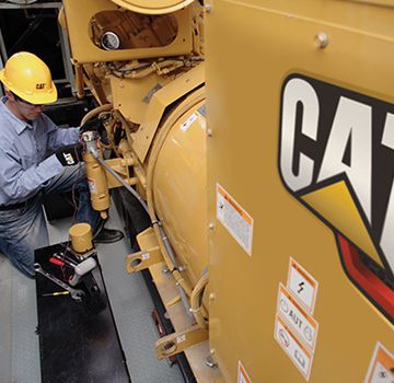 A Carter Cat employee performing electrical testing