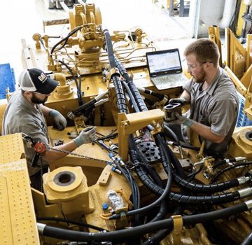 Two Carter Cat employees performing a machine rebuild