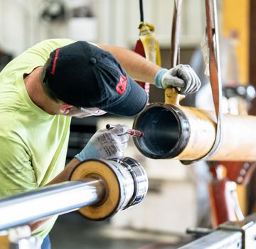 A Carter Cat employee troubleshooting hydraulics