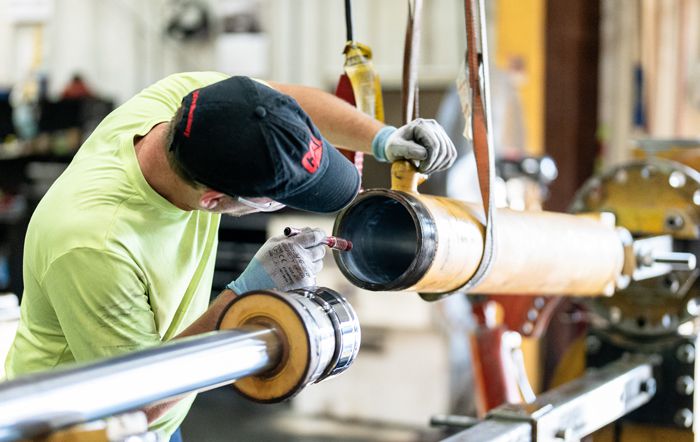 A Carter Cat employee troubleshooting hydraulics