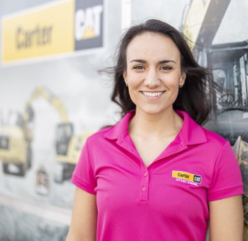 A Carter Cat employee in a bright pink shirt smiling for a photo