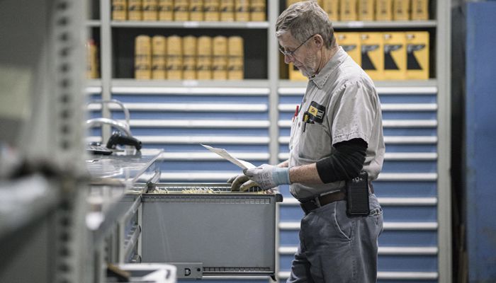 A Carter Cat employee looking through a filing cabinet