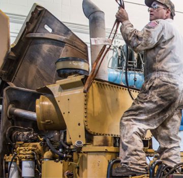 A Carter Cat employee working on a component rebuild