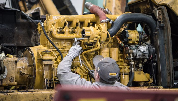 A Carter Cat employee performing a machine rebuild