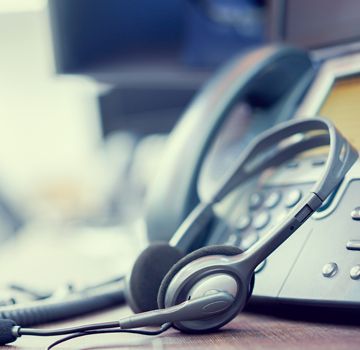 A headset and a landline phone