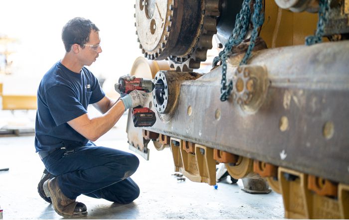 A Carter Cat employee working on a Cat machine