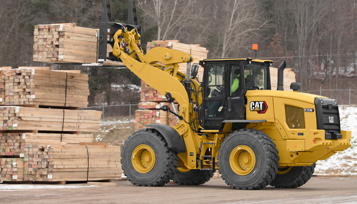 Cat 938M lifting a bundle of lumber